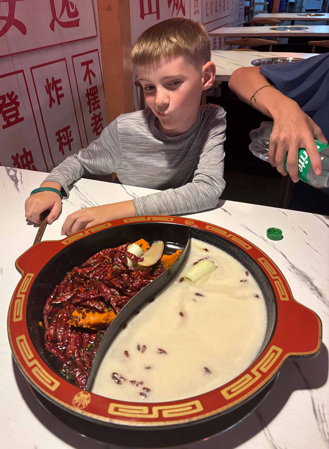 Tim looking skeptical of the number of chillies in the "mild" broth we had ordered