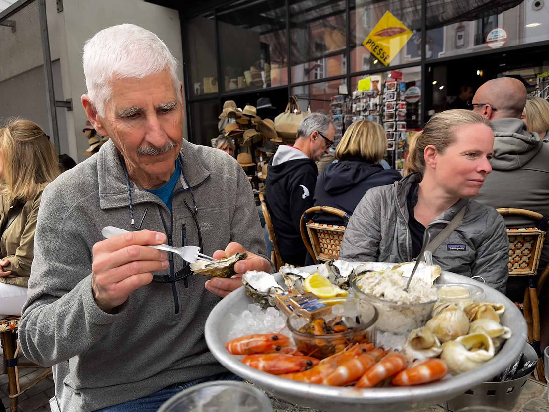 Carol trying not to look at the delicious oysters and snails